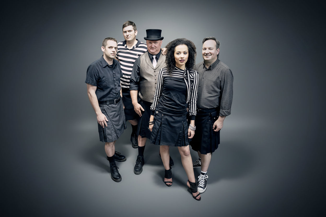 Group of people wearing StumpTown Kilts posing together in a studio setting