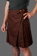 Brown kilt worn by a person on a gray background