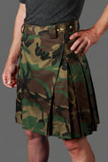 Camouflage kilt worn by a person on a gray background