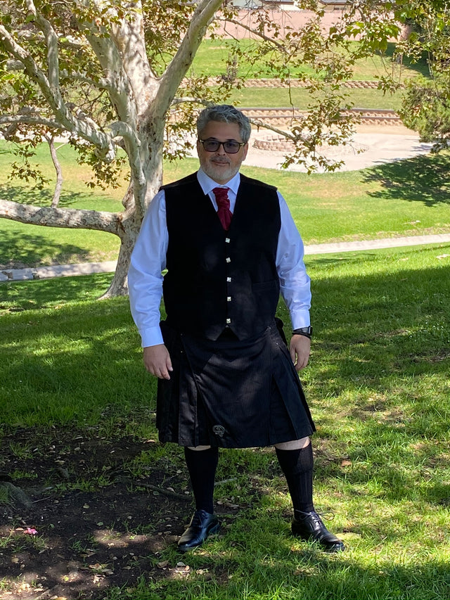 Pinstripe Kilt worn by a male model outside 